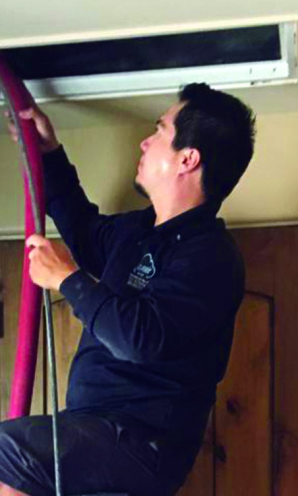 air duct cleaning technician in mesa, az cleaning air duct vent at a customer's house in mesa, arizona